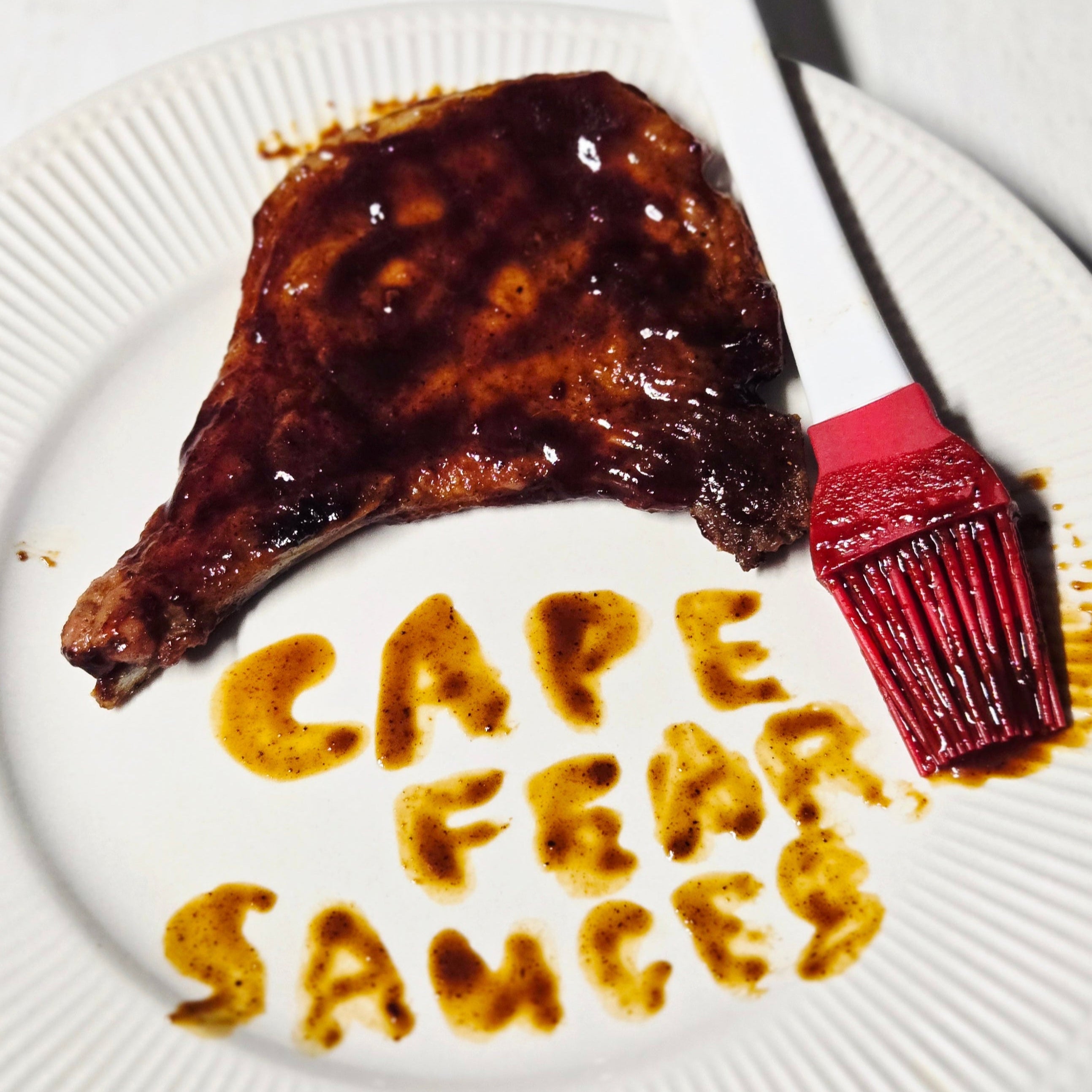 pork chop with cape fear sauces wrote in bbq sauce